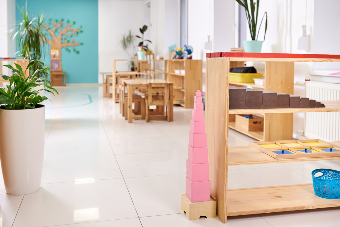 Light class in Montessori kindergarten. The pink tower is in the foreground. nobody