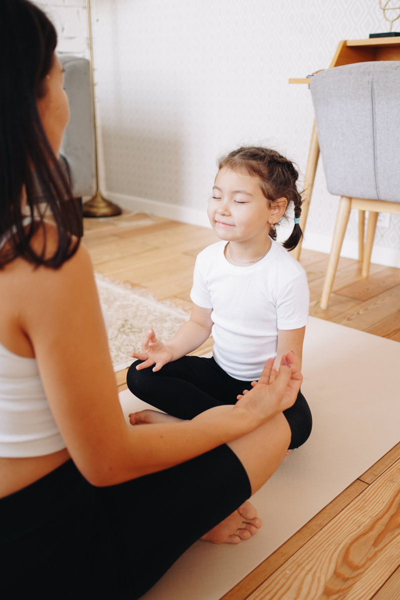 Mother and Child Meditating at Home 